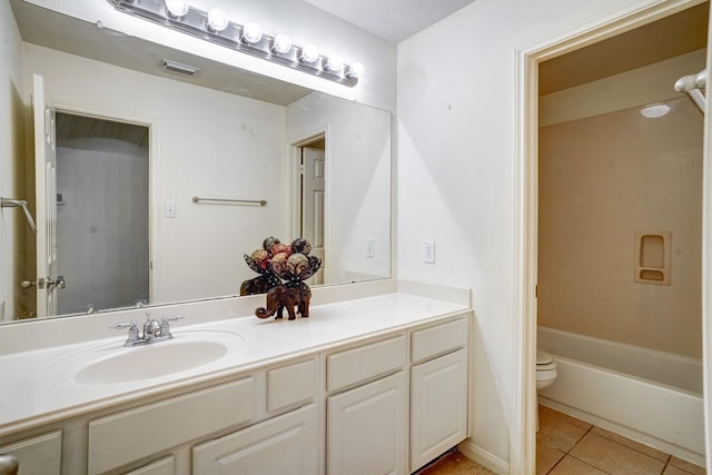 full bathroom featuring tile patterned flooring, vanity,  shower combination, and toilet