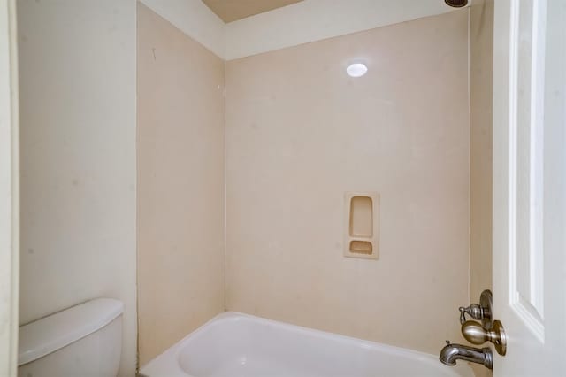 bathroom featuring shower / bath combination and toilet