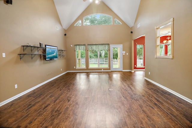 unfurnished living room featuring dark hardwood / wood-style floors and high vaulted ceiling