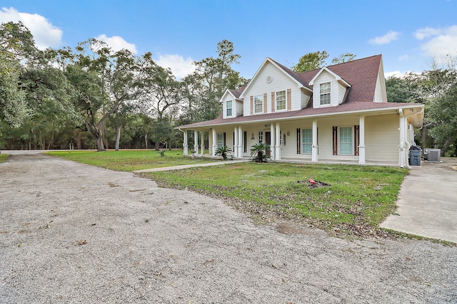 country-style home featuring cooling unit, a front lawn, and a porch