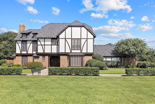 rear view of property with a lawn