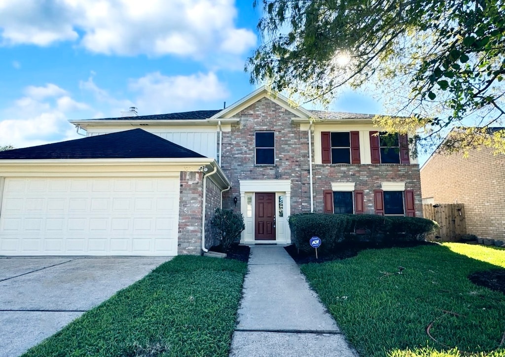 view of front of property with a front lawn and a garage