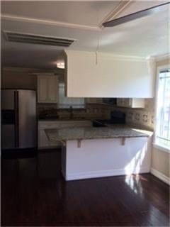 kitchen featuring stainless steel fridge and dark hardwood / wood-style flooring