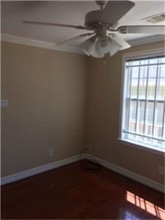 empty room with ceiling fan, dark hardwood / wood-style flooring, and ornamental molding