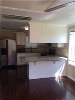 kitchen with stainless steel fridge and dark hardwood / wood-style flooring