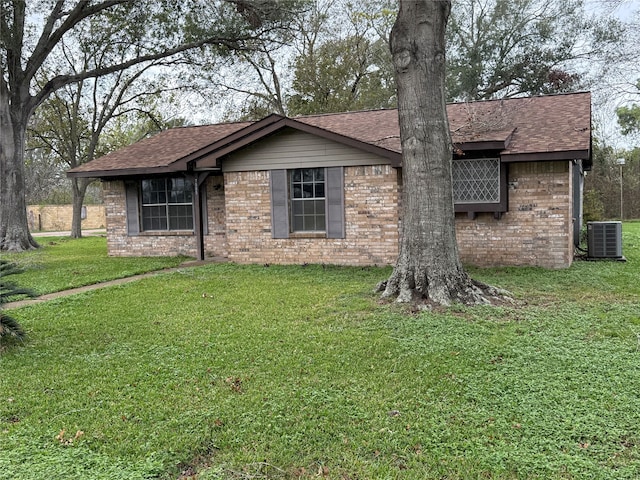 single story home featuring a front lawn and central AC unit