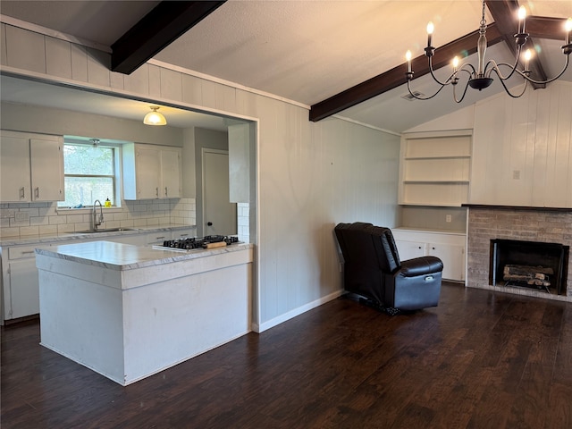 kitchen featuring white cabinets, dark hardwood / wood-style flooring, tasteful backsplash, and sink