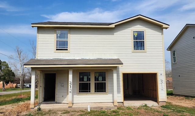 traditional home with covered porch and an attached garage