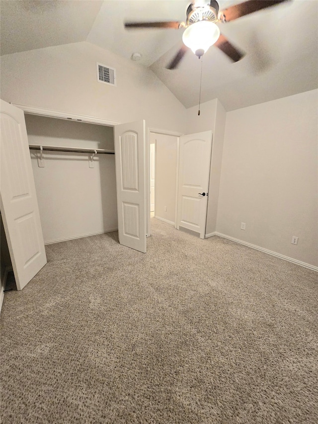 unfurnished bedroom with ceiling fan, a closet, carpet floors, and vaulted ceiling