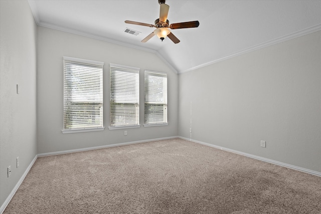 carpeted empty room featuring ceiling fan, vaulted ceiling, and ornamental molding