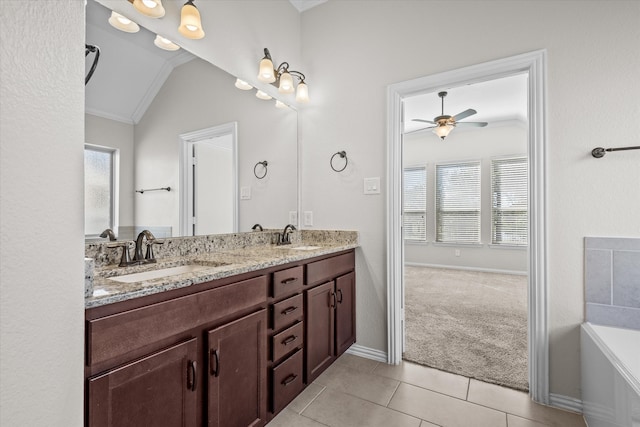 bathroom with tile patterned floors, ceiling fan, a healthy amount of sunlight, and lofted ceiling