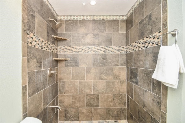 bathroom with tiled shower