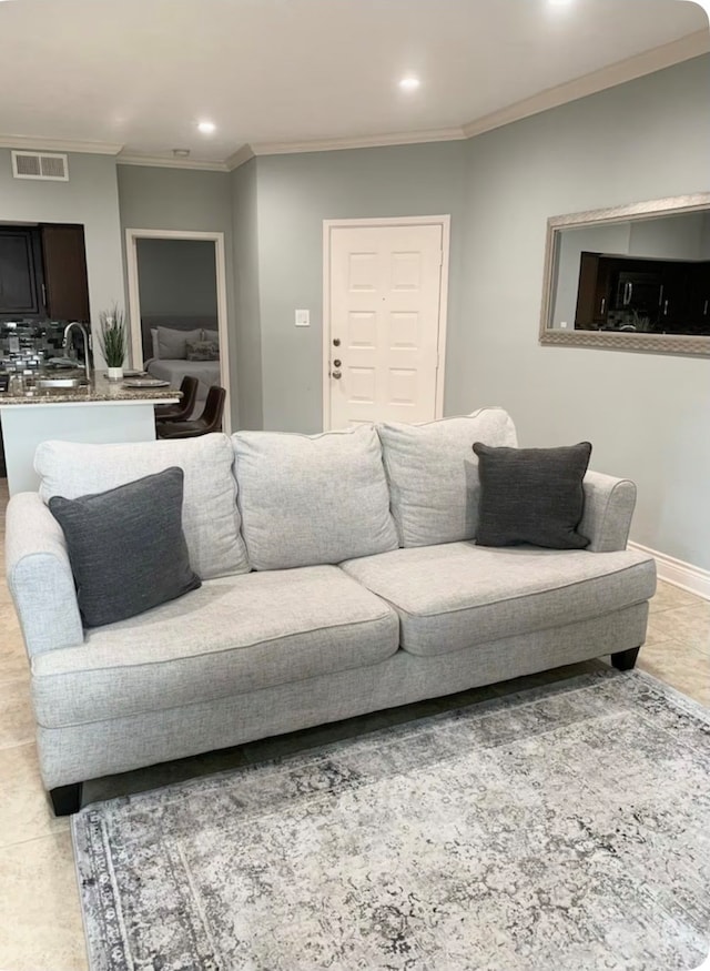 living room with crown molding and sink