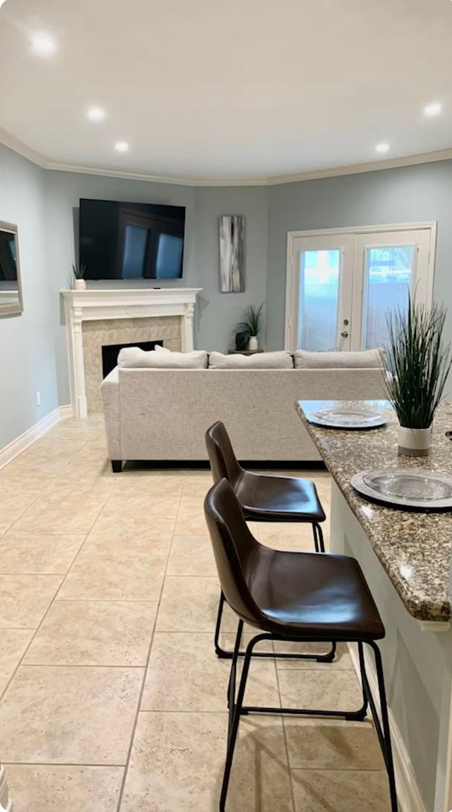 dining room with crown molding and light tile patterned flooring