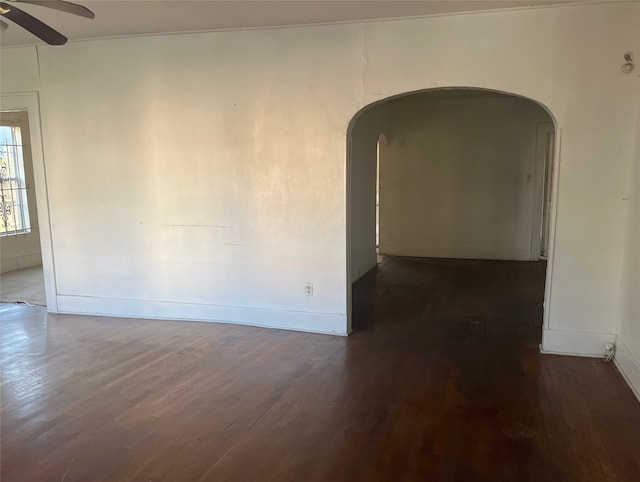 unfurnished room with dark hardwood / wood-style floors and ceiling fan