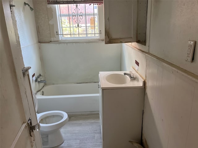 bathroom with hardwood / wood-style floors, vanity, and toilet