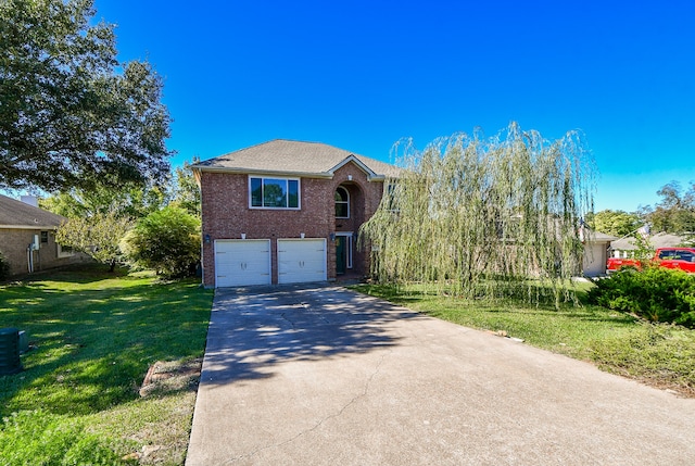 view of front of home with a front lawn and a garage