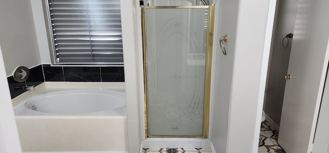 bathroom with tile patterned flooring and independent shower and bath