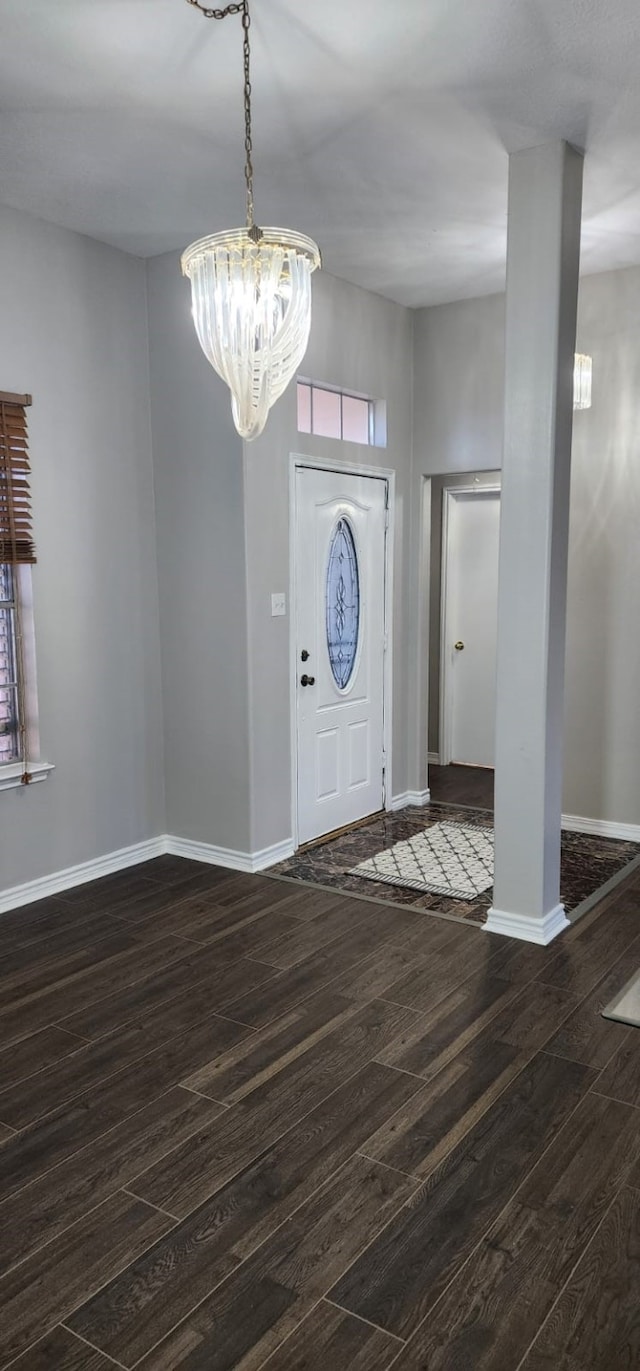 entryway featuring a notable chandelier and dark hardwood / wood-style flooring