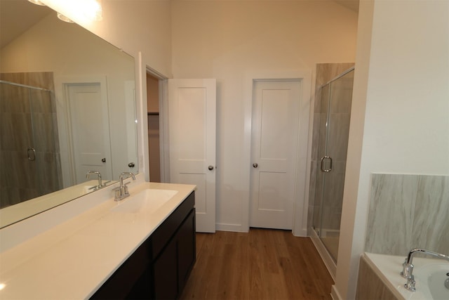 bathroom with vanity, separate shower and tub, and hardwood / wood-style floors