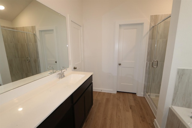 bathroom with lofted ceiling, an enclosed shower, vanity, and hardwood / wood-style flooring