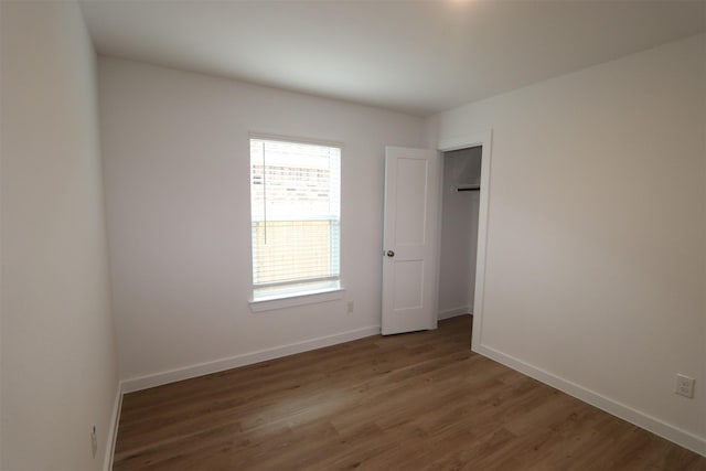 unfurnished bedroom featuring dark wood-type flooring