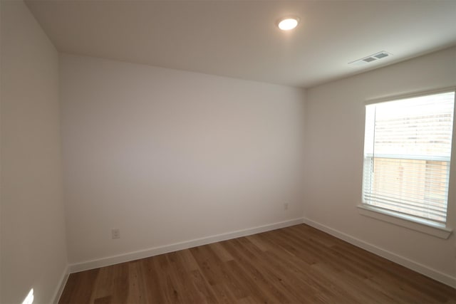 empty room with dark hardwood / wood-style floors