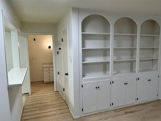 corridor with light hardwood / wood-style flooring