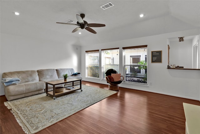 living room with ceiling fan, dark wood-type flooring, and vaulted ceiling