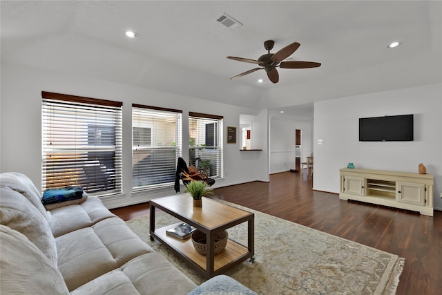 living room with dark hardwood / wood-style flooring and ceiling fan