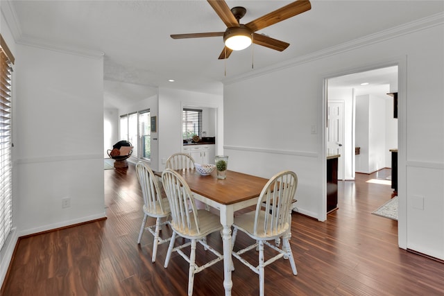 dining area with dark hardwood / wood-style floors, ceiling fan, and ornamental molding