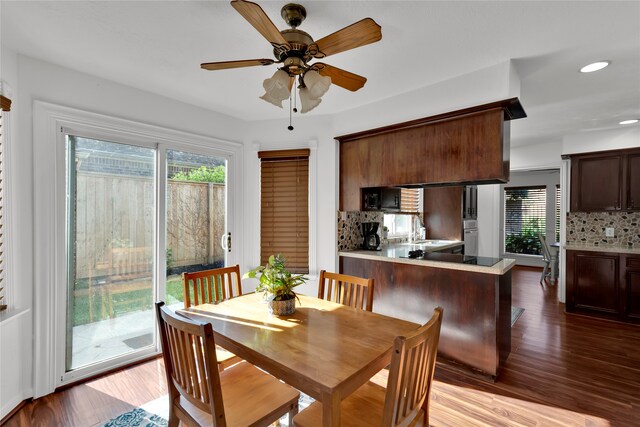 dining space with light wood-type flooring, ceiling fan, and sink