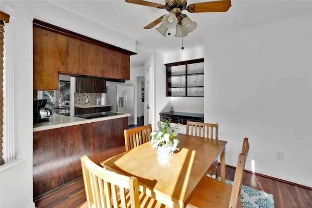 dining space with ceiling fan and dark hardwood / wood-style flooring