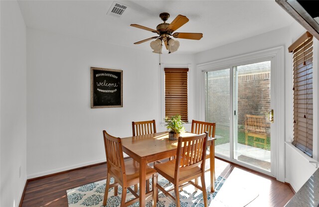 dining area featuring ceiling fan and dark hardwood / wood-style flooring