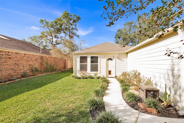 doorway to property with a lawn