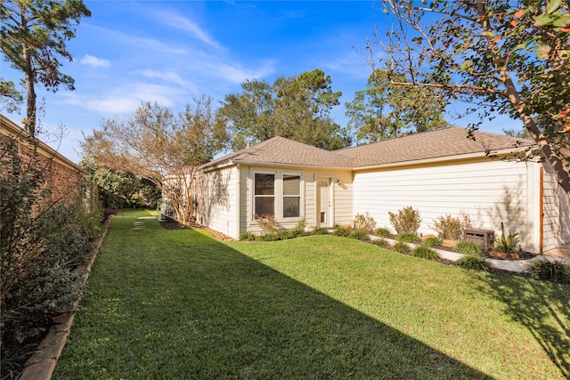 view of property exterior featuring a lawn