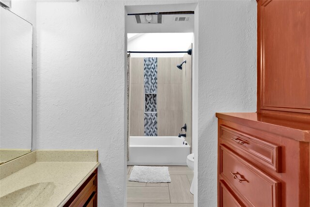 full bathroom with vanity, toilet, and tiled shower / bath