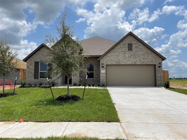 view of front of home featuring a garage and a front yard