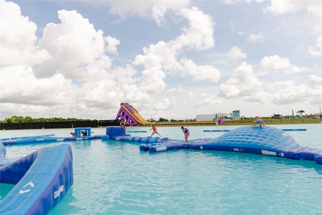 view of swimming pool featuring a water view