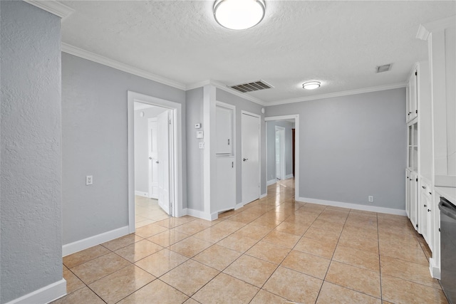 unfurnished room with a textured ceiling, light tile patterned floors, and crown molding