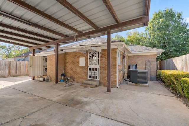 view of patio / terrace with cooling unit and stacked washing maching and dryer