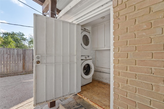 washroom with stacked washer / drying machine