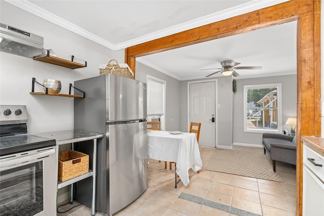 kitchen with appliances with stainless steel finishes, ceiling fan, crown molding, light tile patterned floors, and white cabinetry