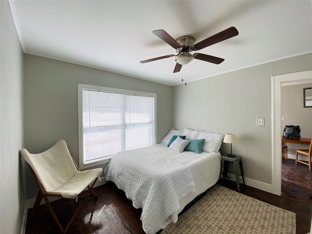 bedroom with ceiling fan, dark hardwood / wood-style floors, and ornamental molding