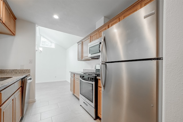 kitchen featuring light tile patterned floors, stainless steel appliances, light stone counters, and lofted ceiling