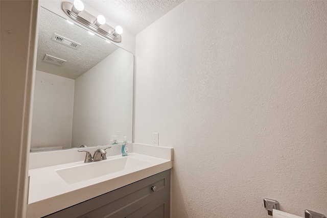 bathroom with vanity and a textured ceiling