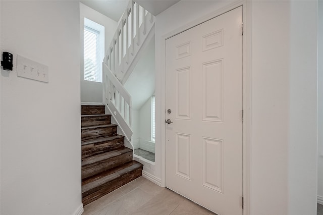 stairs featuring tile patterned flooring