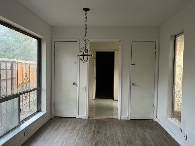 unfurnished dining area with a wealth of natural light and hardwood / wood-style floors