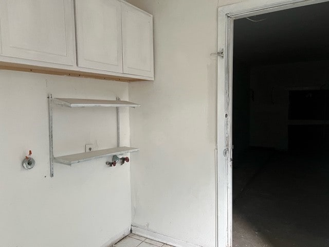 laundry area with cabinets