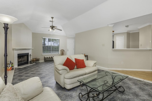 living room featuring ceiling fan, dark hardwood / wood-style flooring, vaulted ceiling, and ornamental molding